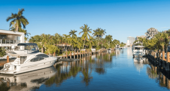 Fort Lauderdale waterfront mansion with a yacht in the front