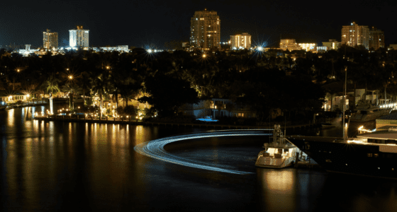 Fort Lauderdale city landscape at night with lights of buildings reflecting on the water