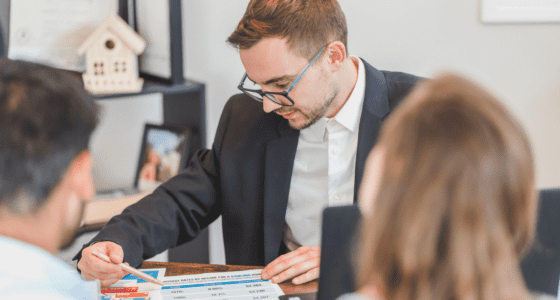 Real estate agent talking to a young couple