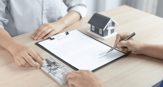Tenant signing rental agreement, while handling money