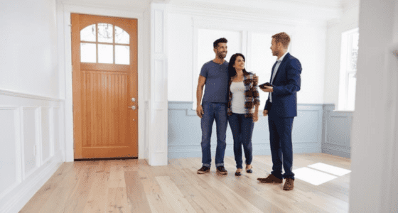 Realtor showing a property to a young couple