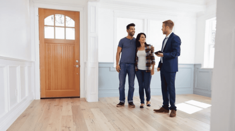 Realtor Showing A Property To A Young Couple