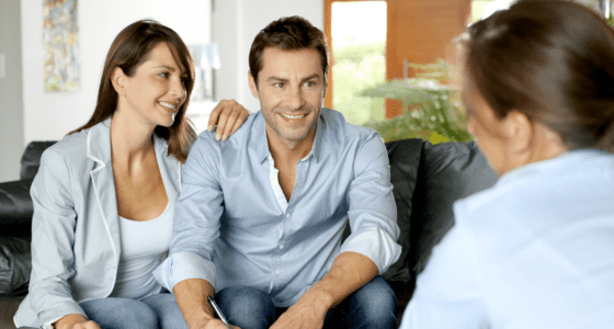 Young couple with a realtor ready to sign a contract