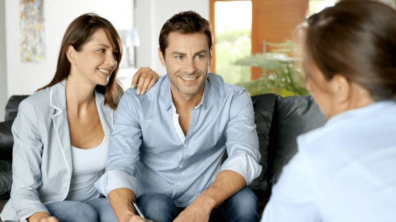 Young Couple With A Realtor Ready To Sign A Contract