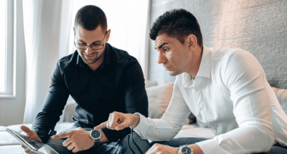 A gay couple discussing house options on a tablet