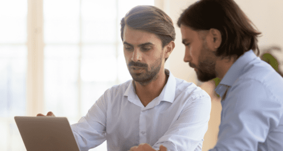 two man looking for properties online
