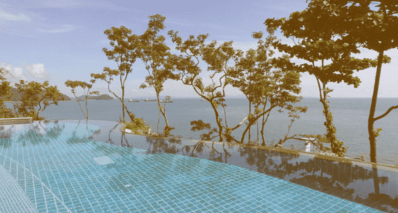 Large infinite pool with ocean view.
