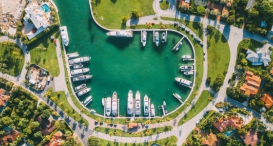 Drone view of a cul-de-sac canal with moored boats, on a residential area