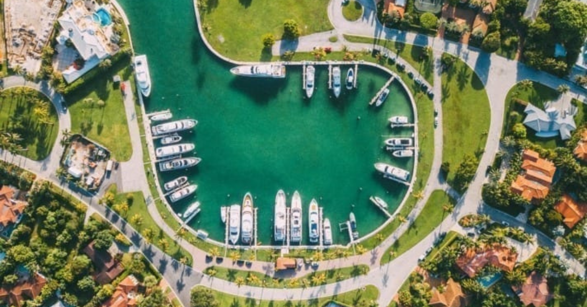Drone View Of A Cul-de-sac Canal With Moored Boats, On A Residential Area