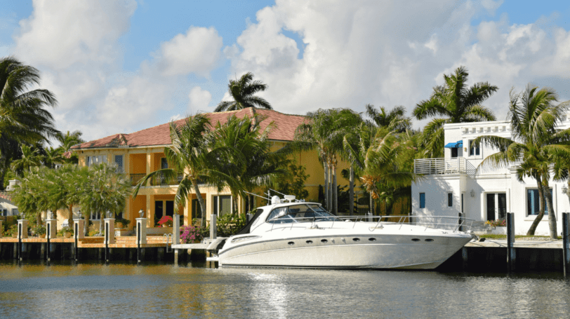 Luxury Waterfront Homes With A Boat Moored In The Front