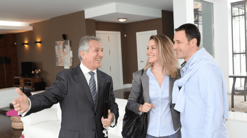 Real Estate Agent Showing Modern House To Couple